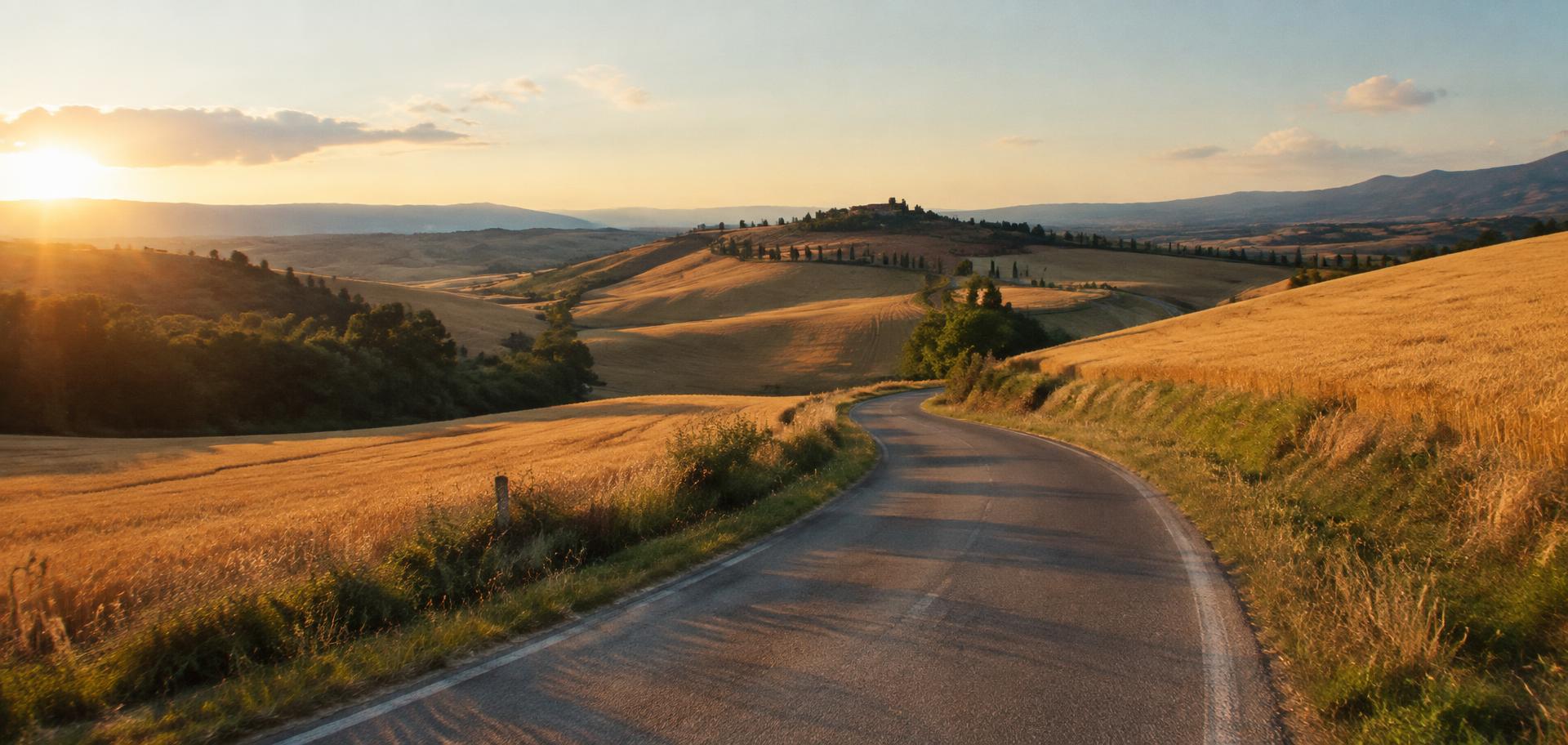 A winding country road through golden fields
